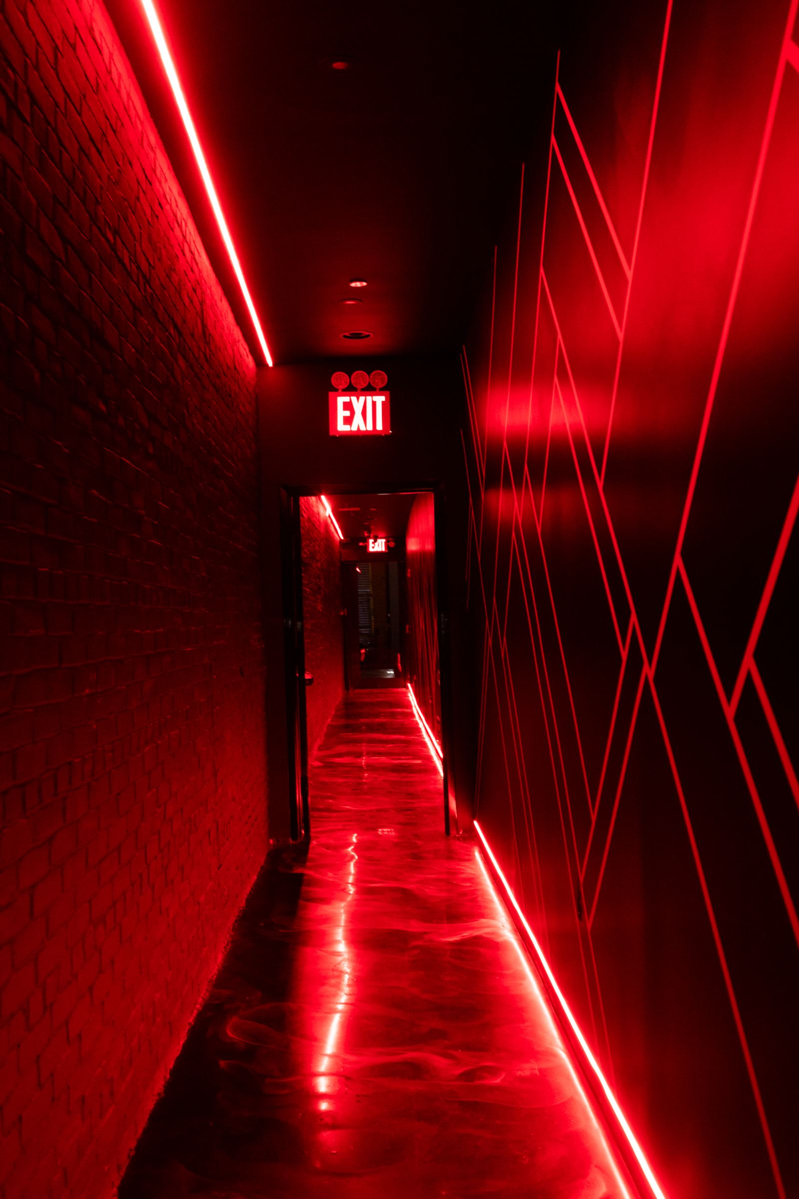 Red neon walkway leading into Partake